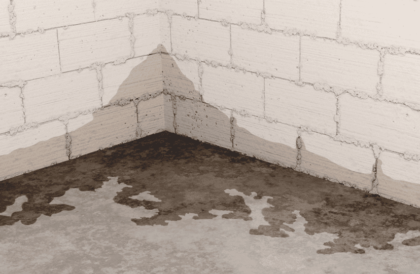 Illustration of water staining and pooling on a concrete basement floor and block foundation wall due to hydrostatic