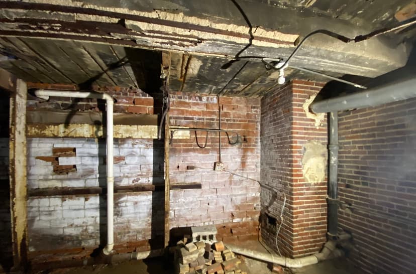 Epp Foundation Repair inspecting heavy mold growth and efflorescence on basement brick walls in Lincoln, NE.
