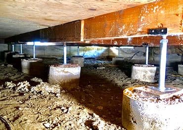 Epp Foundation Repair installing adjustable smart jacks on concrete piers to support crawl space wooden beams.