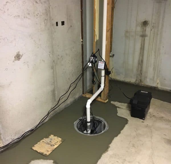 Epp Foundation Repair installing a sump pump with battery backup in a basement.
