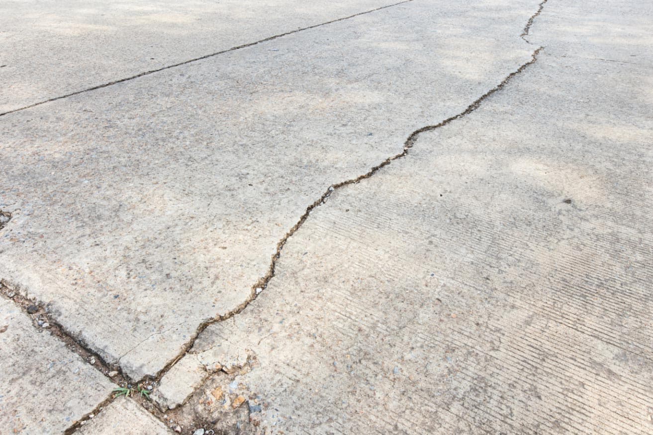 Early warning signs of cracked driveway on a Midwest home