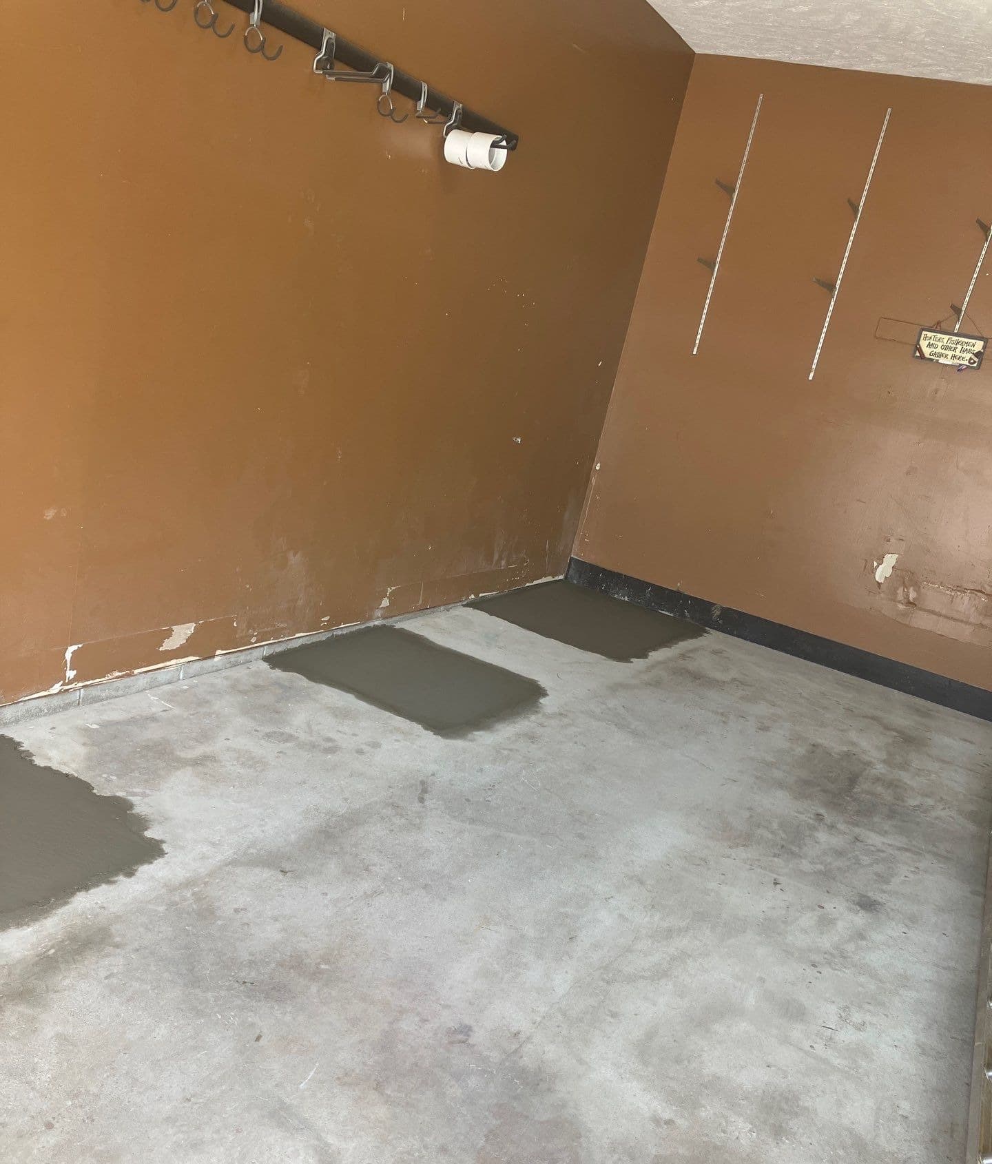 Epp Foundation Repair crew completing concrete patching and void filling in a concrete floored interior in Bellevue, NE.