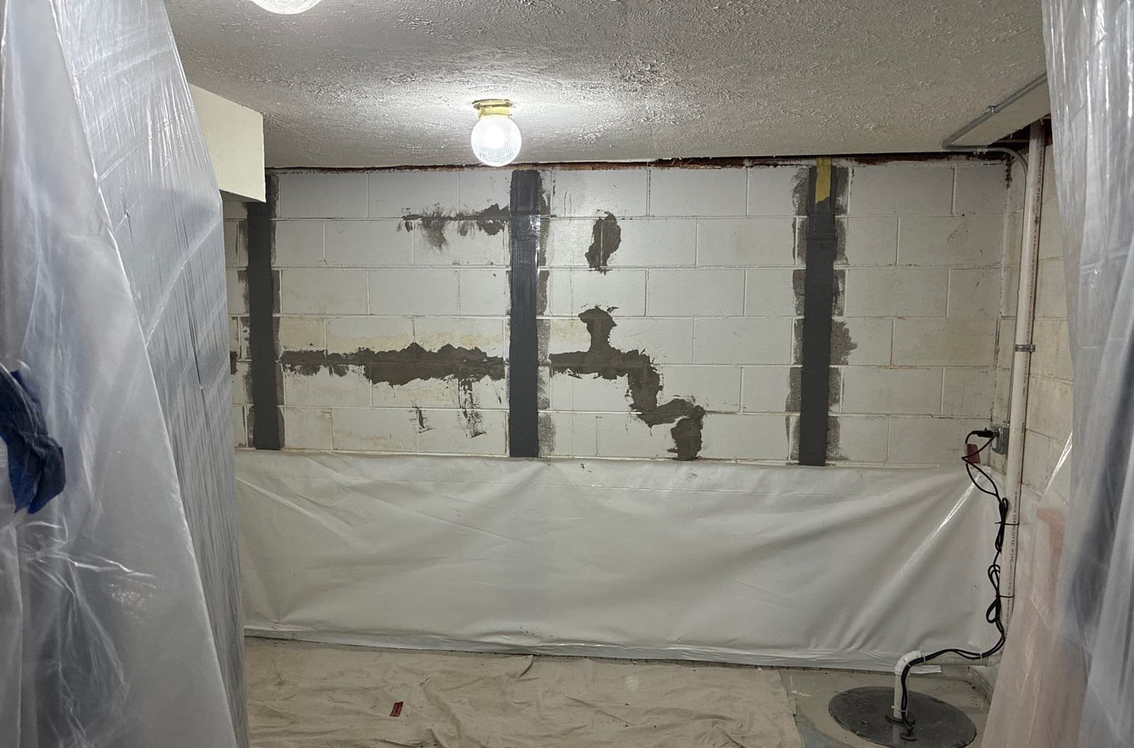 Epp Foundation Repair installing carbon fiber straps for basement wall repair with a new vapor barrier and sump pump in Kearn
