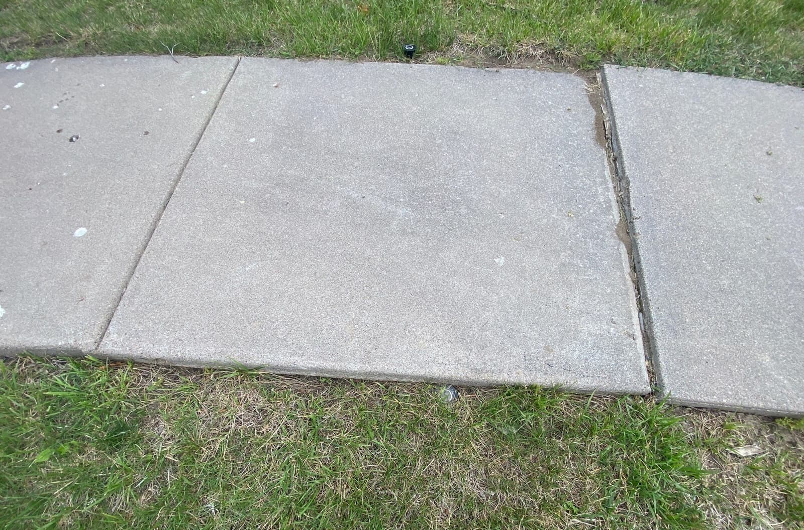 Early warning signs of sinking sidewalks on a Midwest home