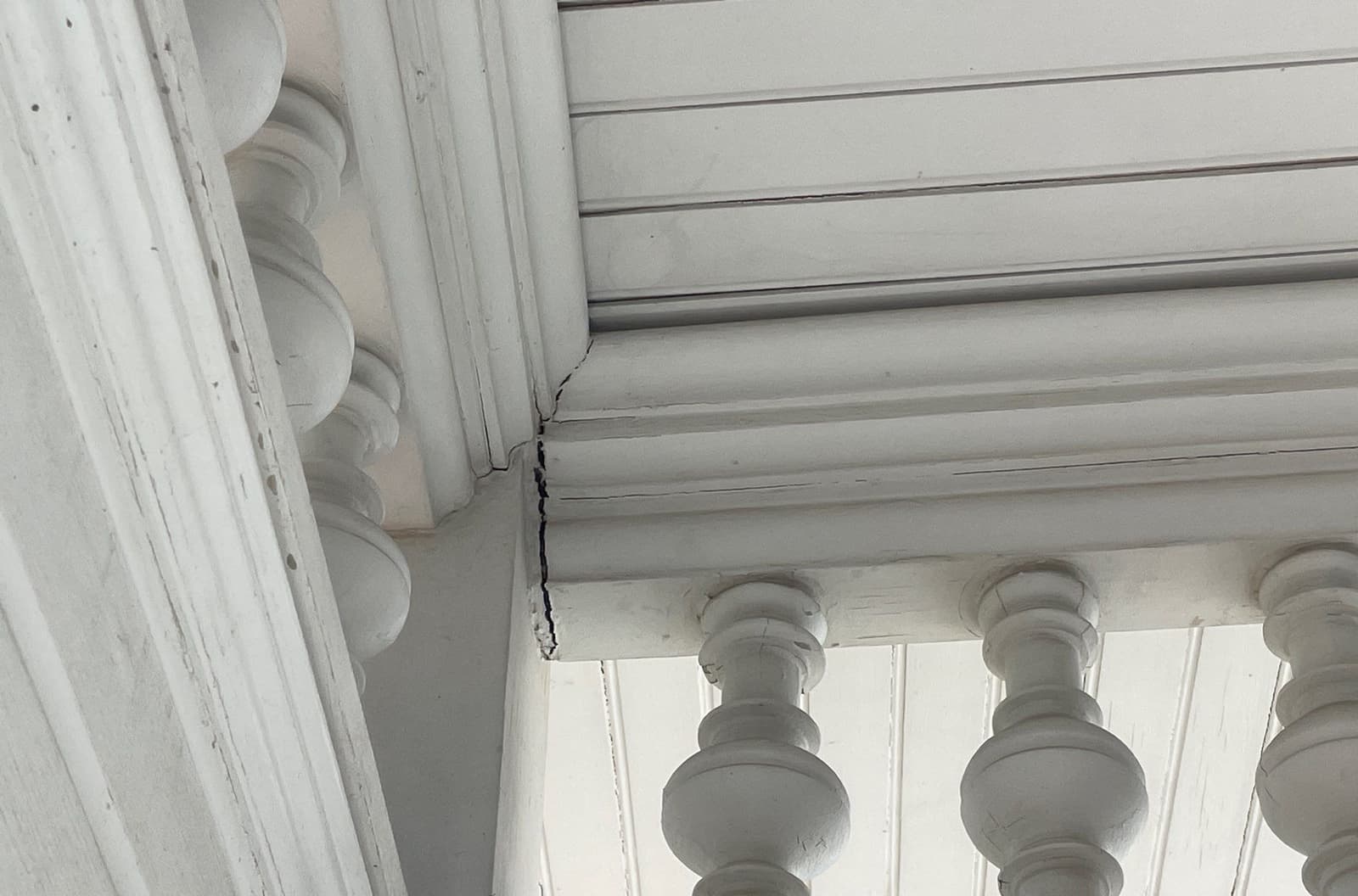 Epp Foundation Repair inspecting a severe vertical crack in a decorative concrete staircase baluster in Kearney, NE.