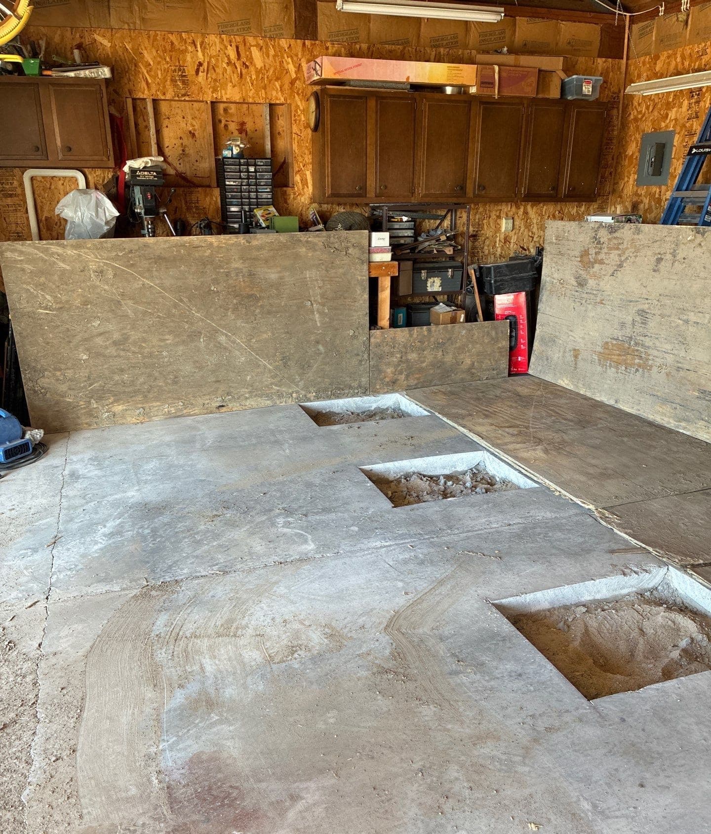 Epp Foundation Repair inspecting and preparing a cracked garage floor for void filling in Cozad, Nebraska.