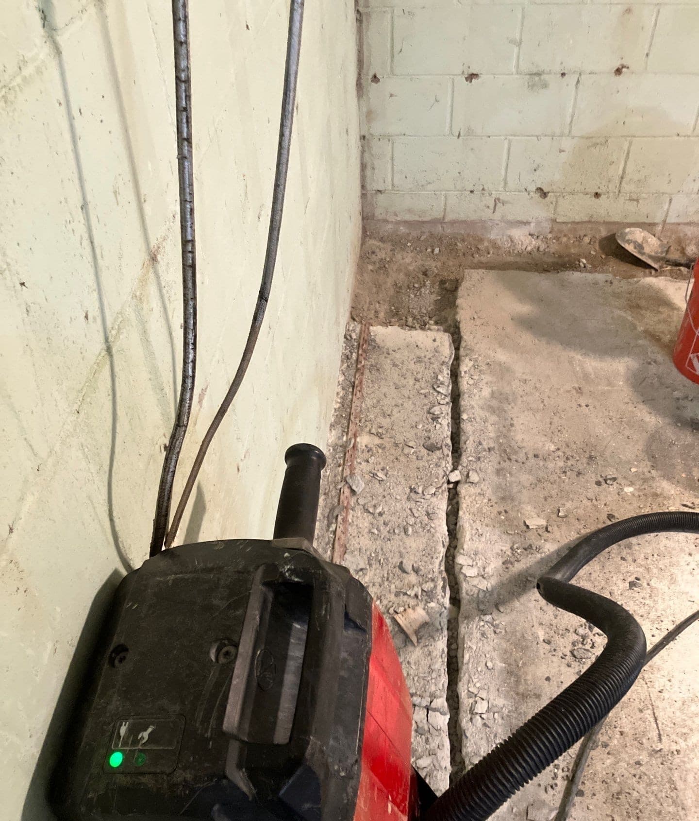 Epp Foundation Repair crew cutting a concrete trench for a drainage system installation in Omaha, Nebraska.