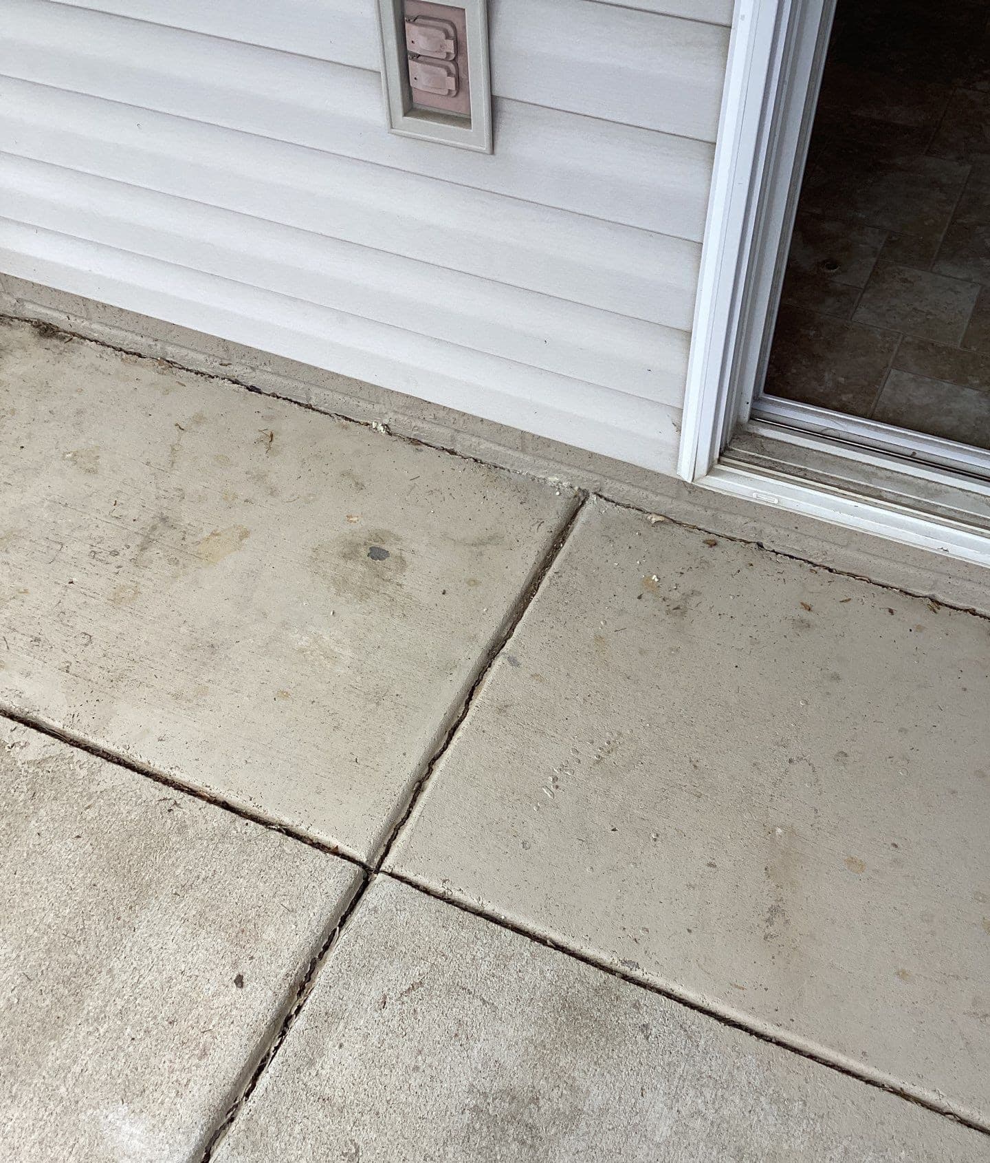 Epp Foundation Repair inspecting cracking expansion joints and surface cracks on a concrete slab patio in Lincoln, nebraska.
