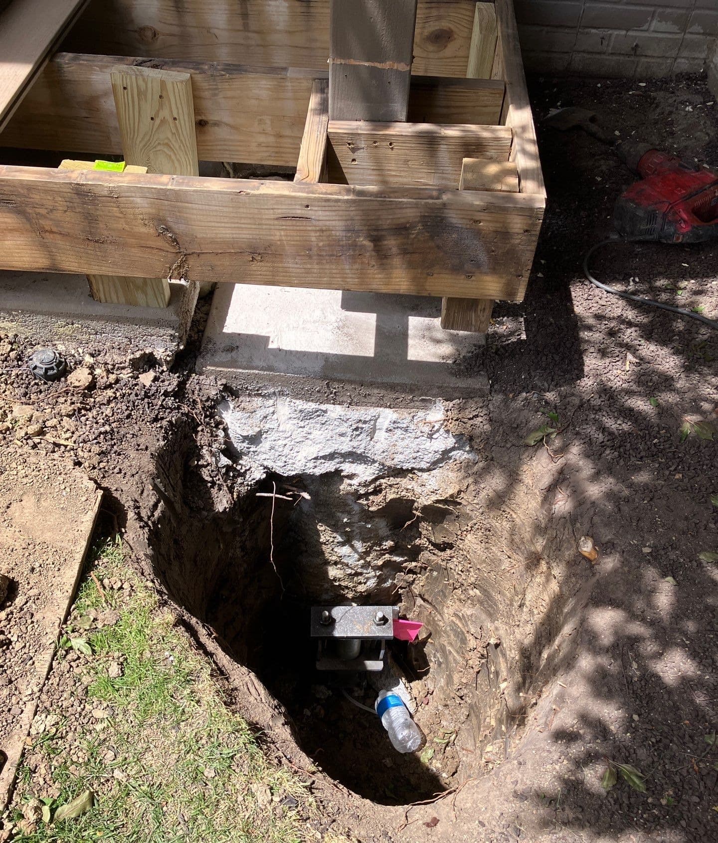 Epp Foundation Repair installing helical deck piers to stabilize a wooden deck in Lincoln, NE.