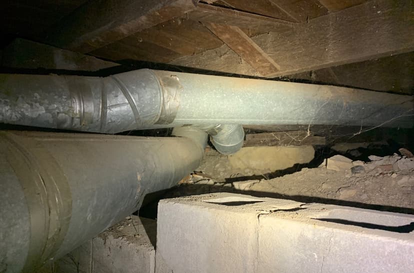 Epp Foundation Repair inspecting a crawl space with a cracked block foundation and old HVAC ducts in Beatrice, NE.