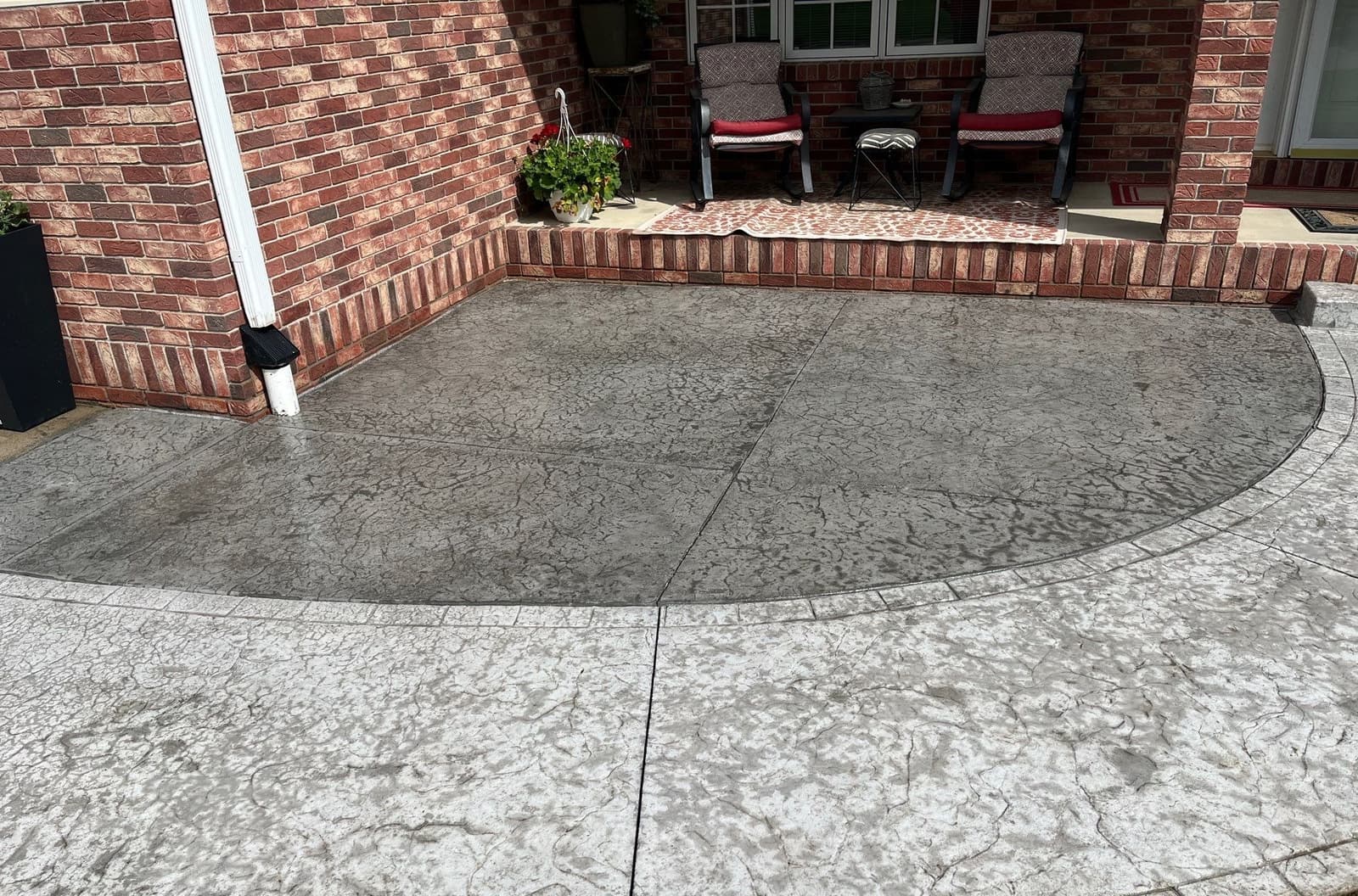 Epp Foundation Repair inspecting cracks in a stamped concrete patio slab in Crete, Nebraska.