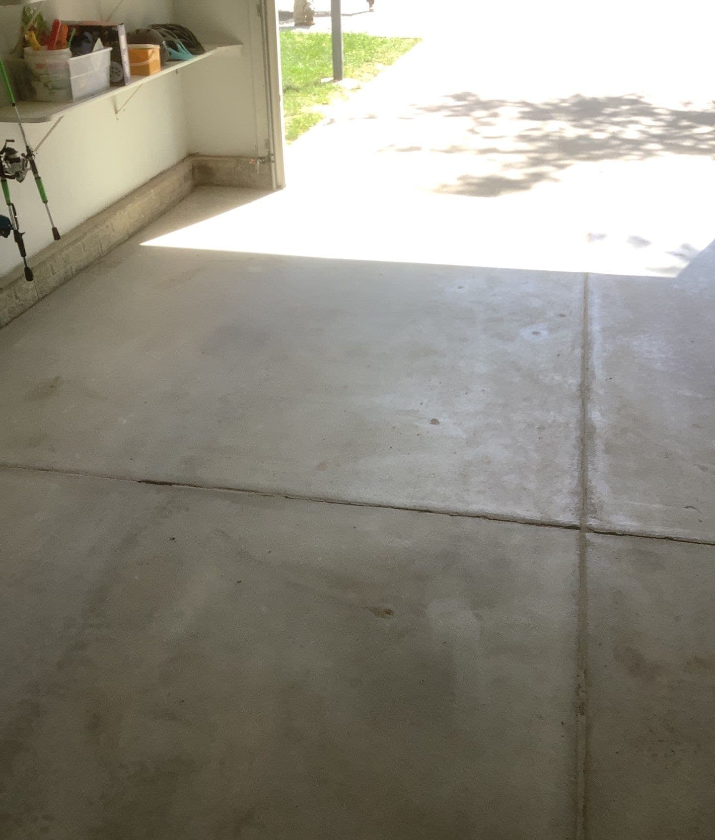 Epp Foundation Repair inspecting a cracked garage floor along an expansion joint for signs of slab settlement in Lincoln, Neb