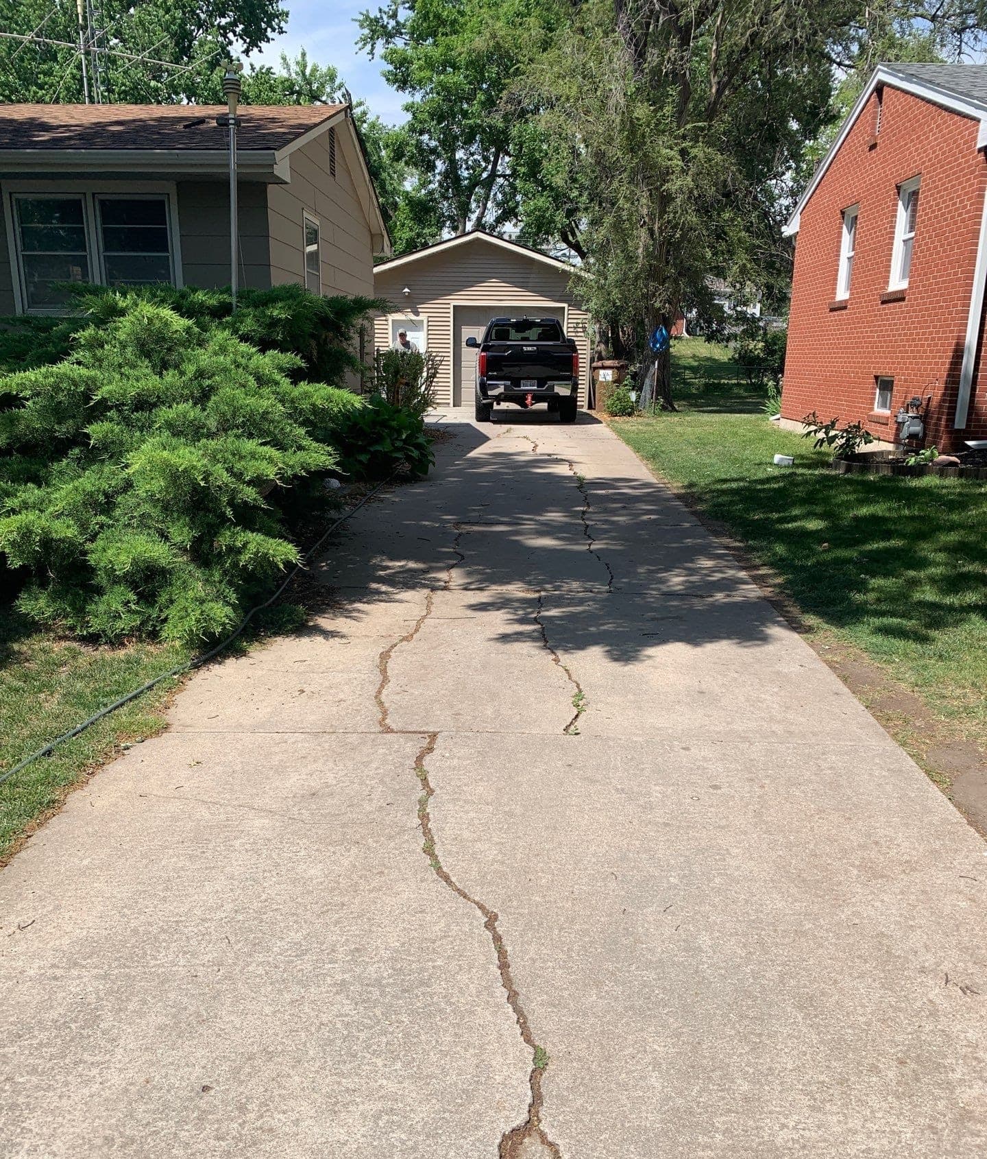 Epp Foundation Repair inspecting a severely cracked concrete driveway at a residential property in Lincoln, NE.