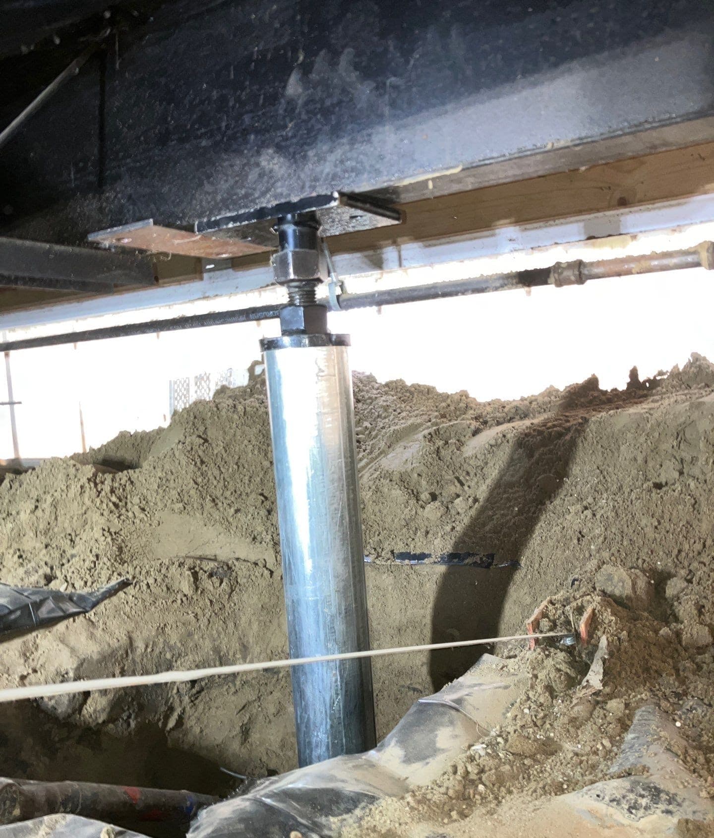 Epp Foundation Repair installing an adjustable steel support jack for crawl space structural repair and floor leveling.