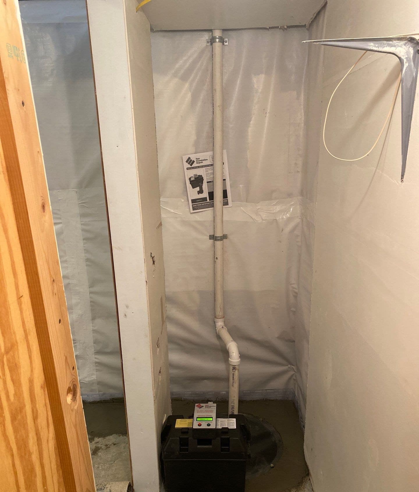 Epp Foundation Repair installing a backup sump pump system with a battery and vapor barrier in a basement in Beatrice, NE.