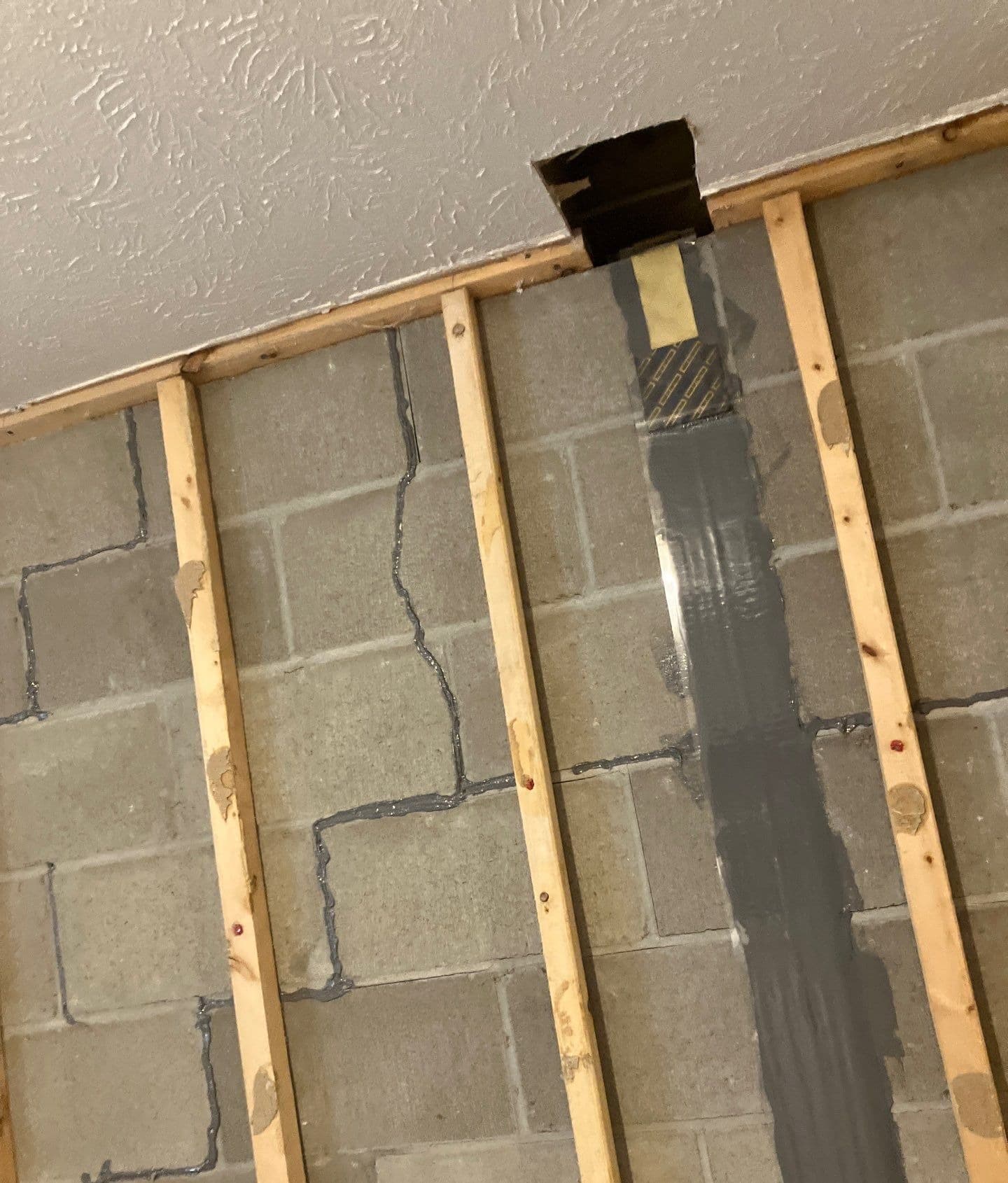 Epp Foundation Repair installing carbon fiber reinforcement on a cracked block foundation wall in Lincoln, NE.