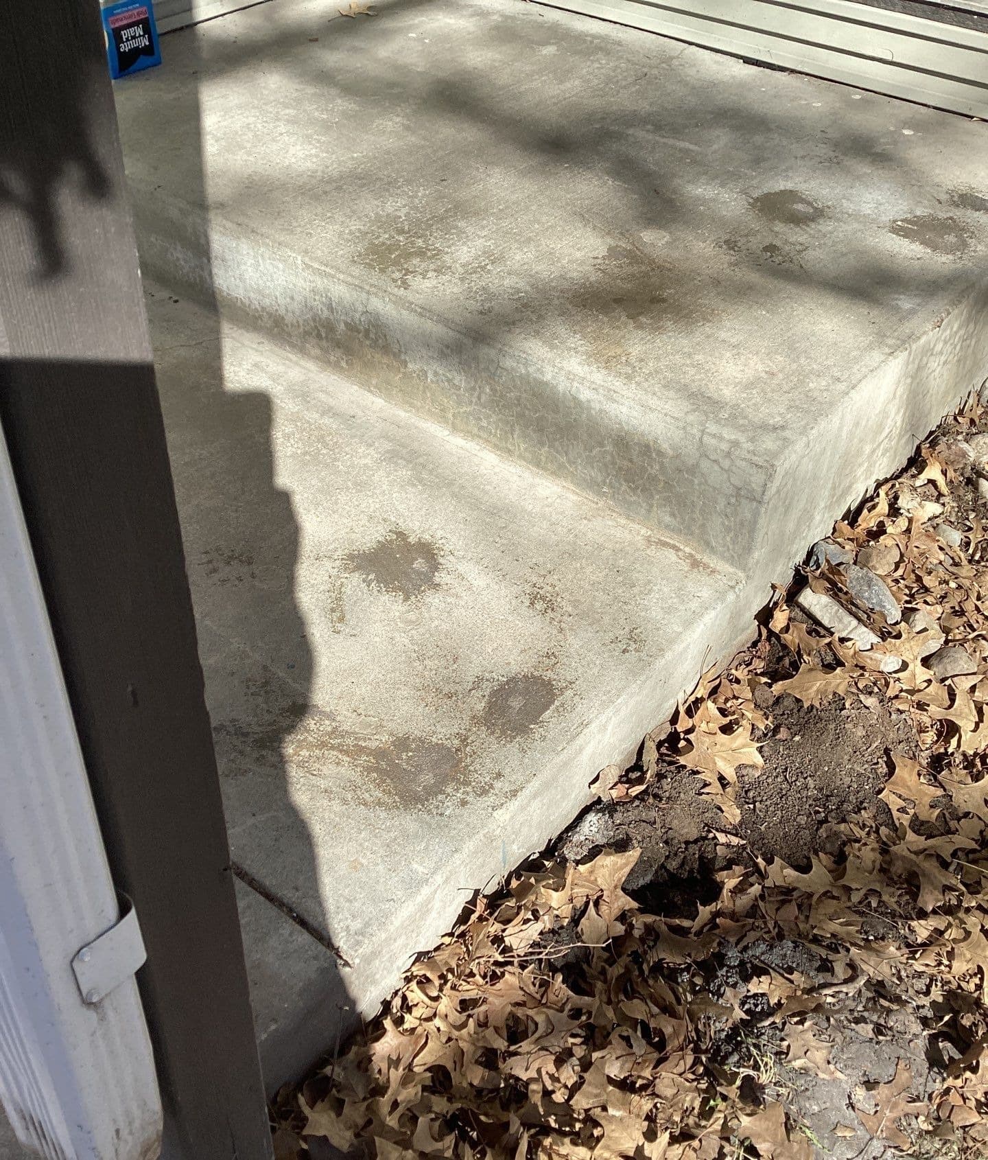 Epp Foundation Repair inspecting hairline cracks in concrete steps and surrounding area in Lincoln, NE.
