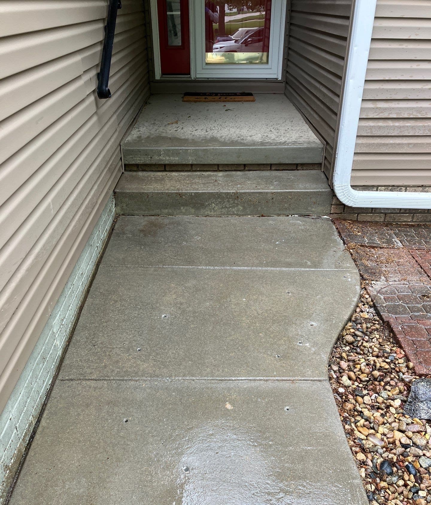 Epp Foundation Repair crew preparing concrete walkway and steps for leveling with drilled holes in Lincoln, Nebraska.