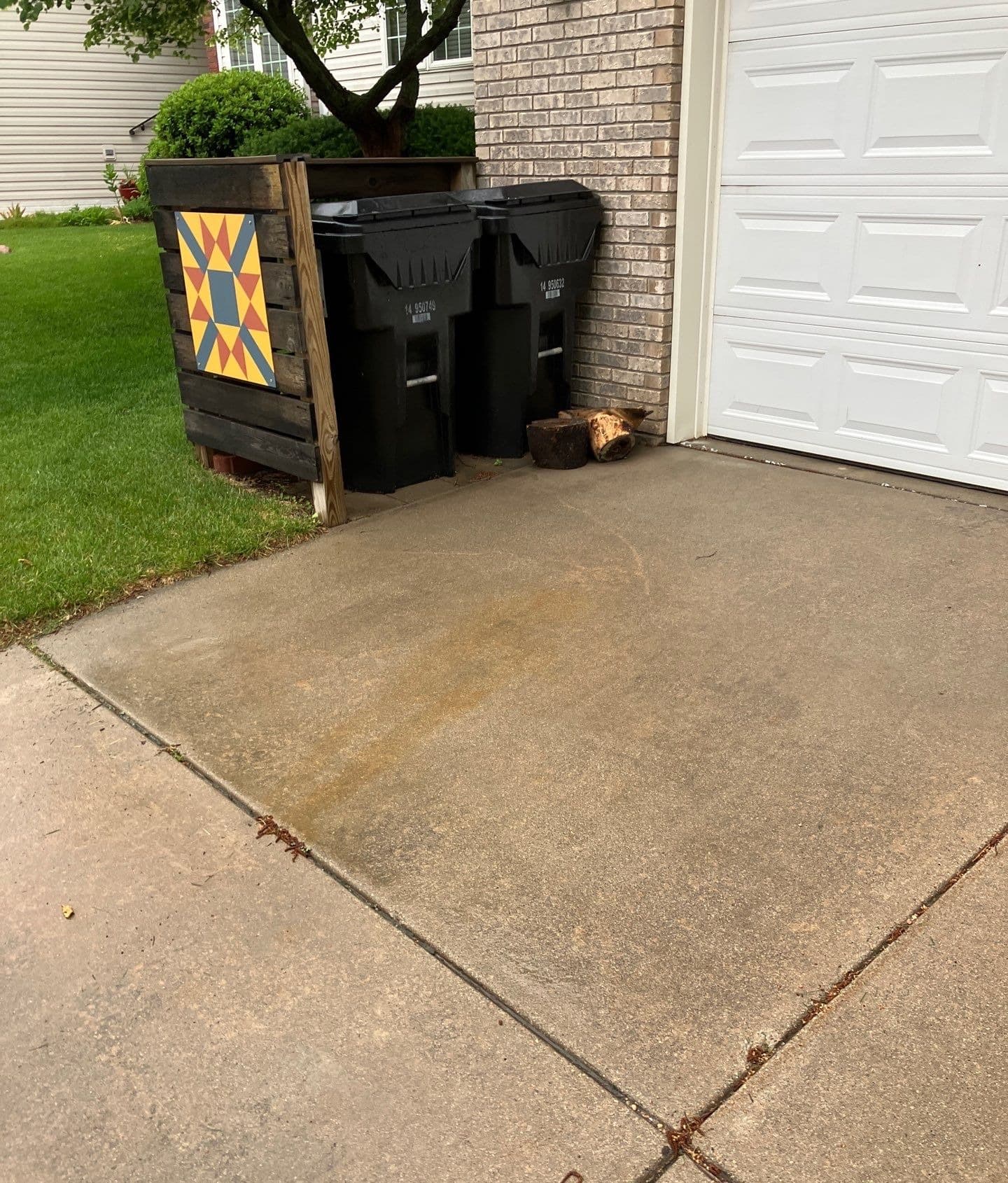 Epp Foundation Repair inspecting cracked concrete driveway with expansion joint issues at a residential home in Lincoln, Nebr