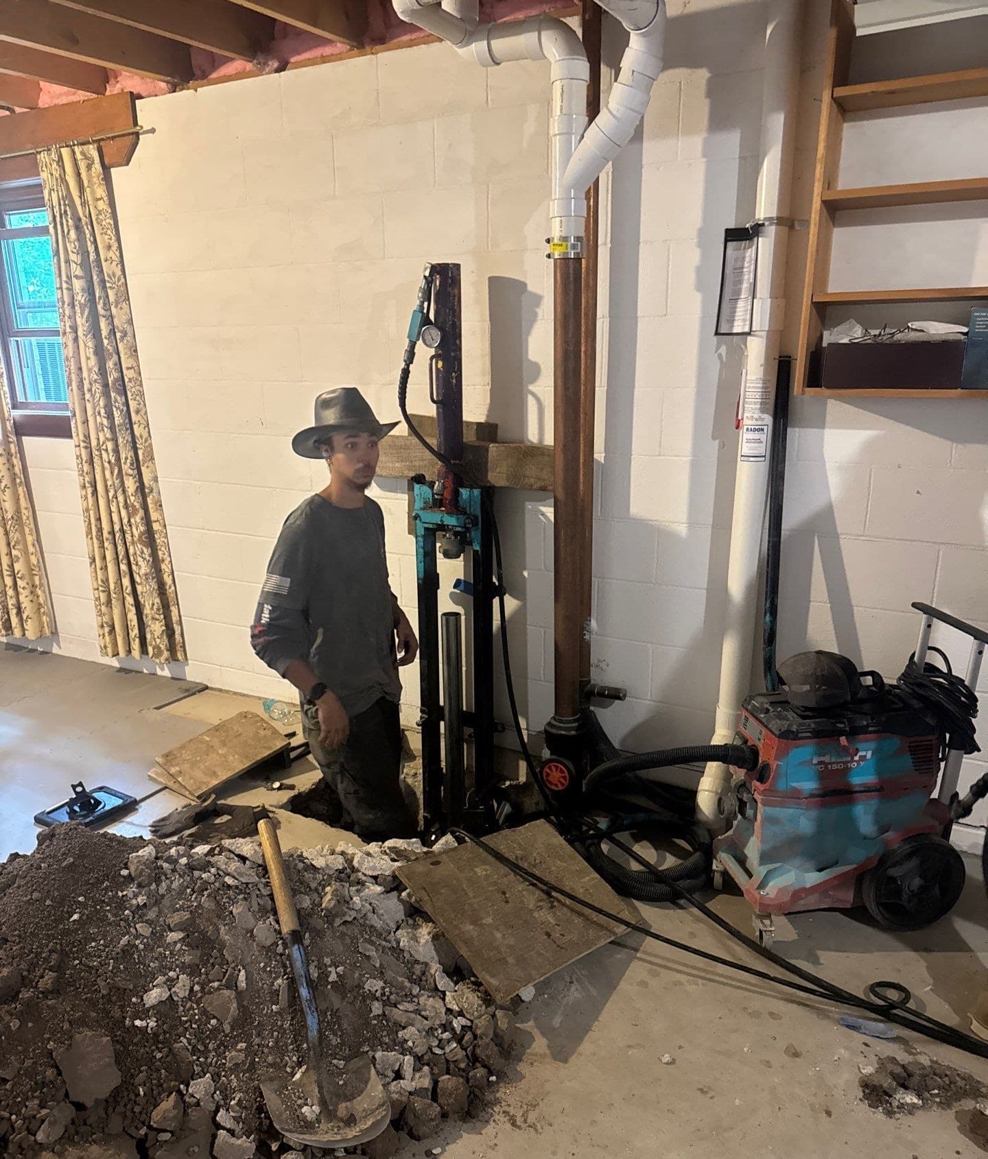 Epp Foundation Repair technician installing a concrete pier for structural support in a basement in Lincoln, Nebraska.