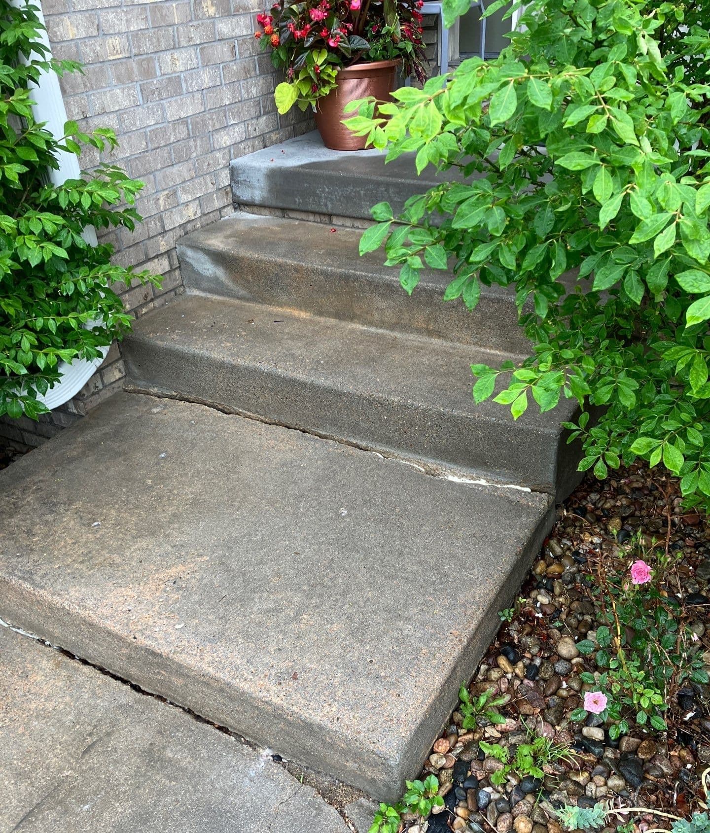 Epp Foundation Repair inspecting sinking concrete steps and sidewalk with a large crack in Lincoln, NE.