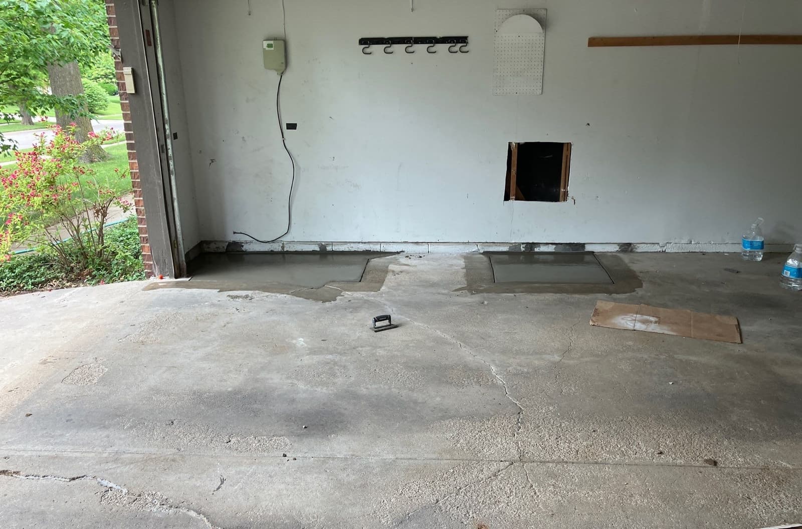 Epp Foundation Repair repairing a cracked garage floor with new concrete patches and leveling.