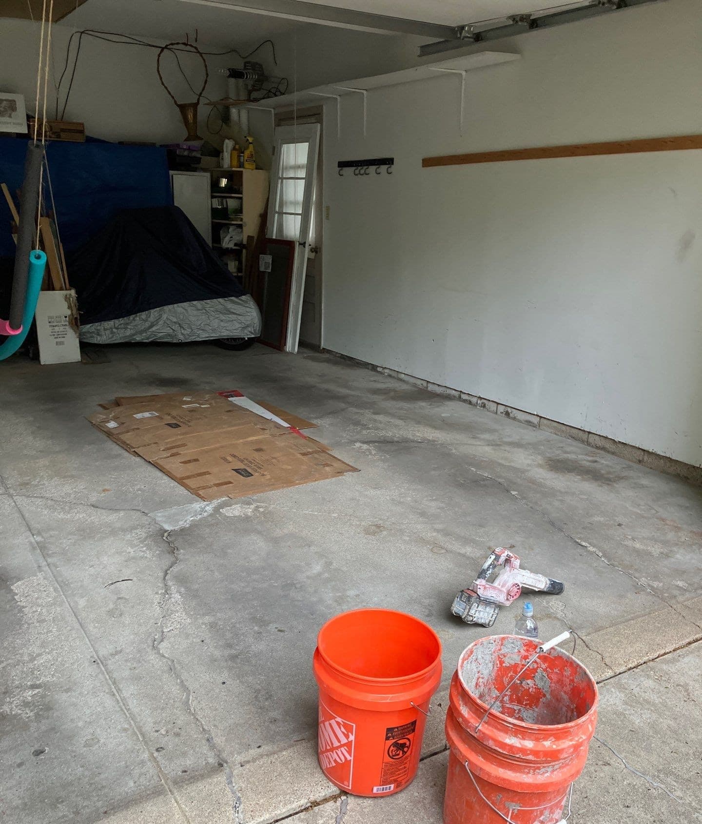 Epp Foundation Repair inspecting and preparing a cracked garage floor for concrete repair.