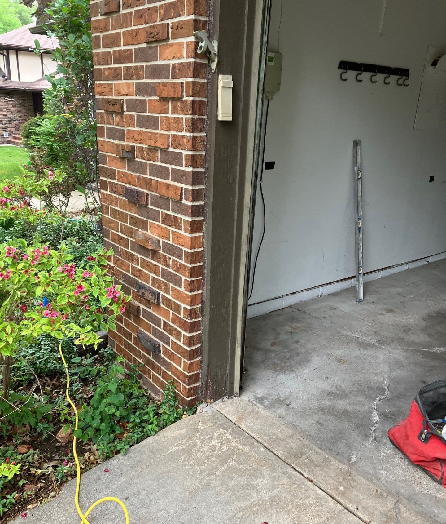 Epp Foundation Repair inspecting cracked concrete on a residential driveway and garage entrance.