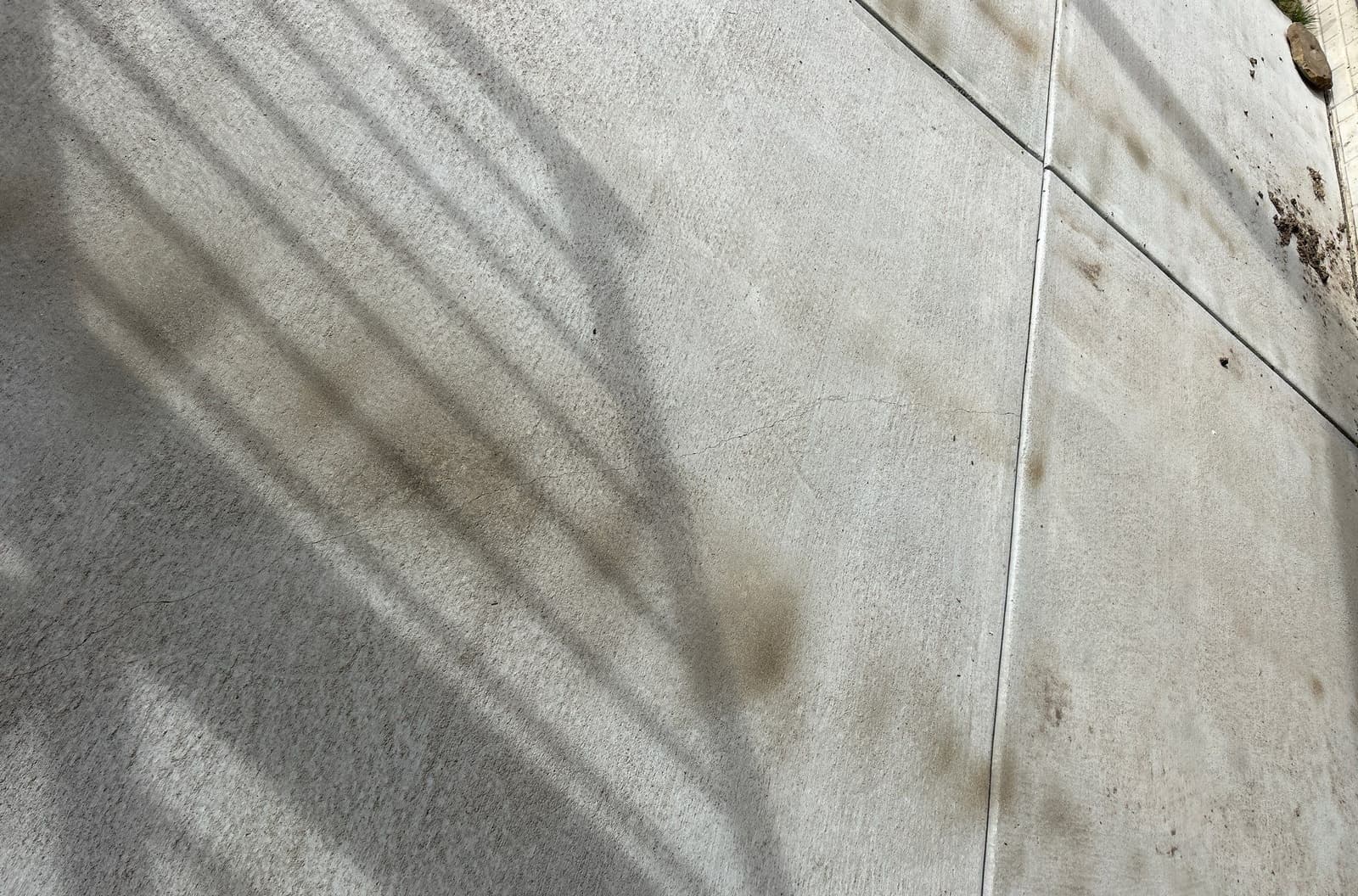 Epp Foundation Repair inspecting cracks in concrete with visible expansion joints in Davey, Nebraska.