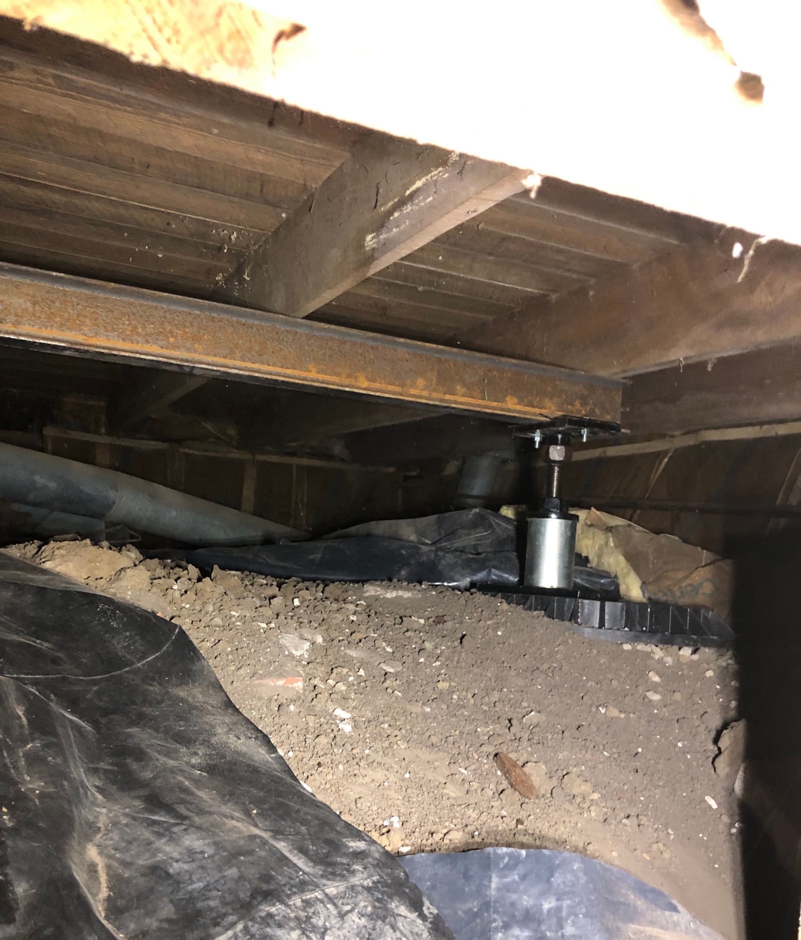 Epp Foundation Repair installing adjustable smart jacks and a vapor barrier in a crawl space in Lincoln, NE.