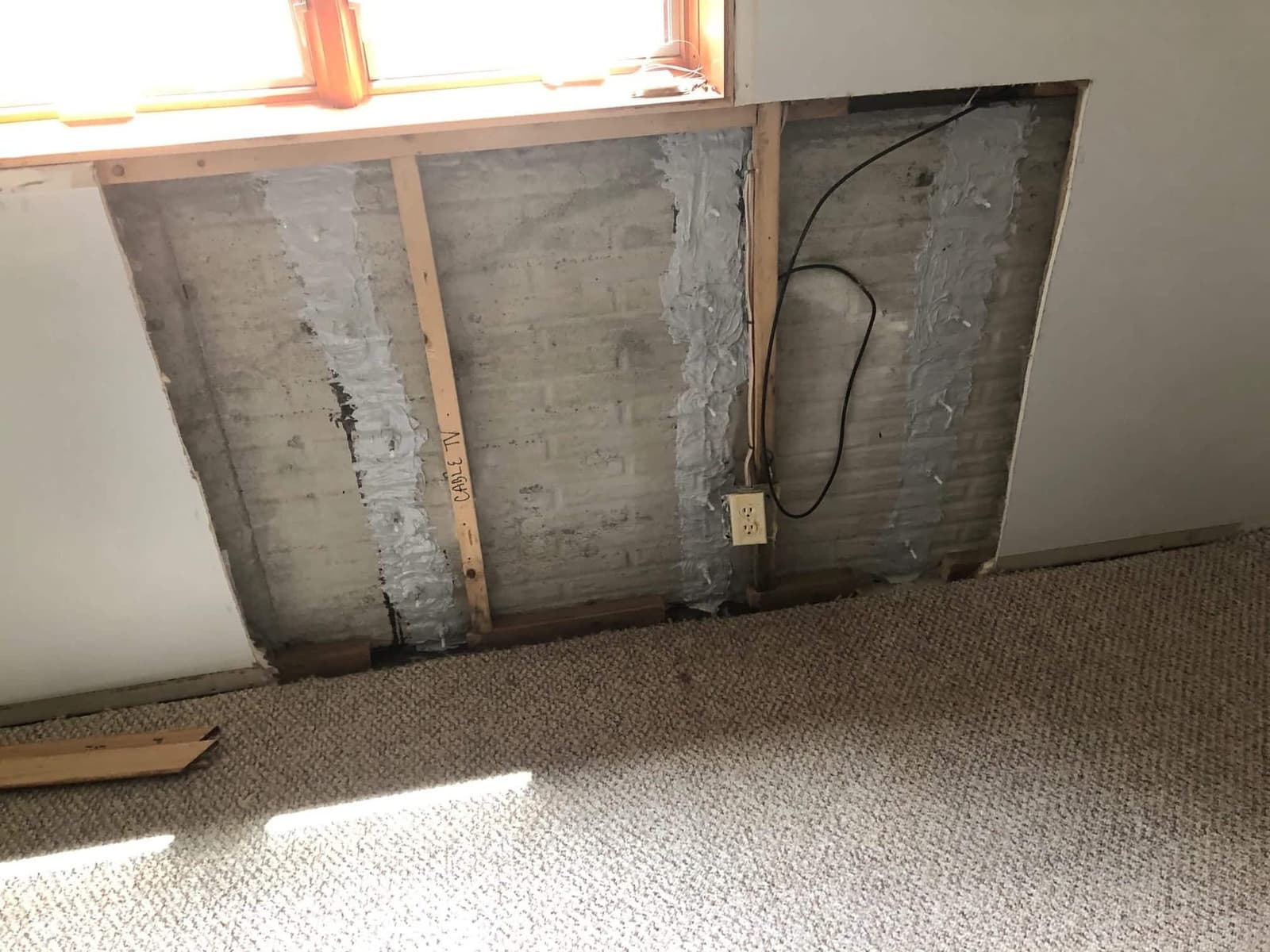 Epp Foundation Repair, exposed block foundation wall with vertical cracks sealed by polyurethane injection.