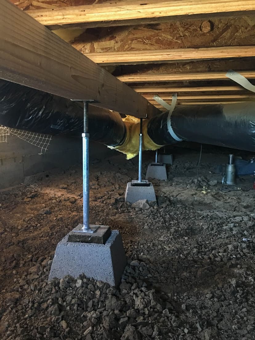 Epp Foundation Repair installing adjustable smart jacks to stabilize a crawl space beam.