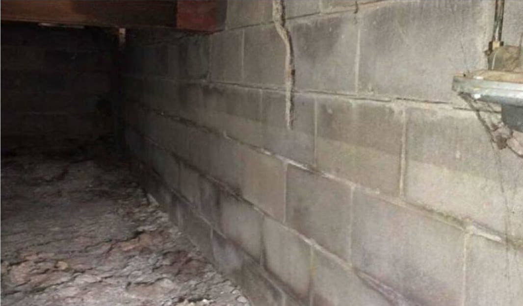 Horizontal crack running across a foundation wall
