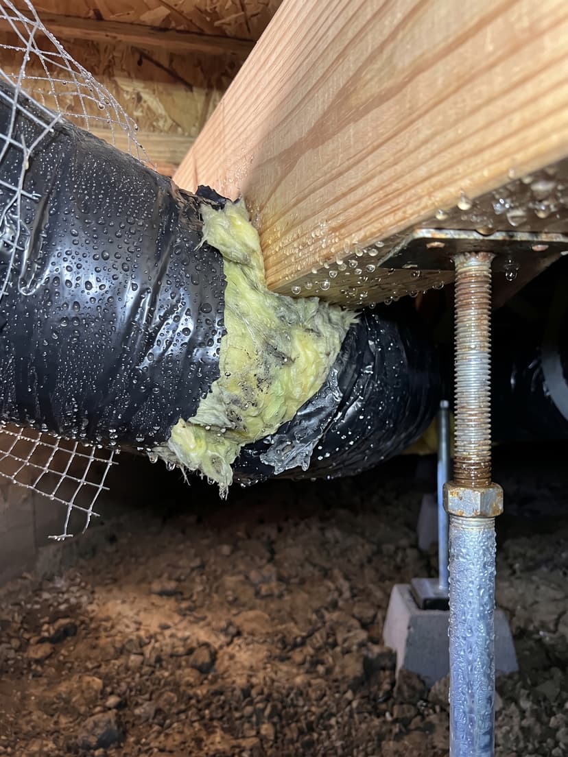 Epp Foundation Repair inspecting condensation on HVAC ductwork and insulation in a crawl space.