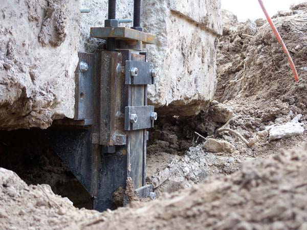 Underpinning involves extending the foundation deeper into stable soil to provide additional support and prevent further movement.